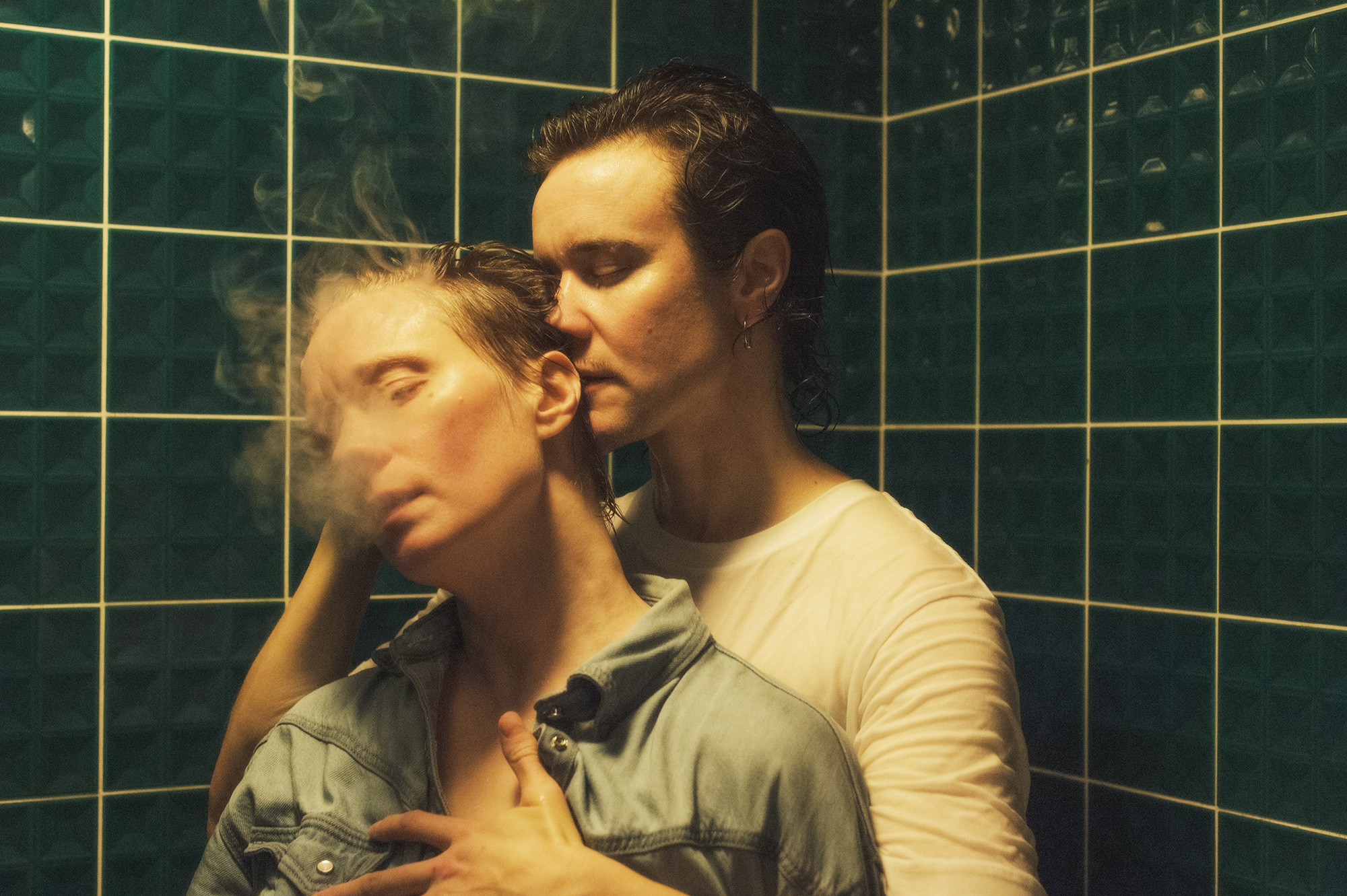 Portrait of two people in a tiled room